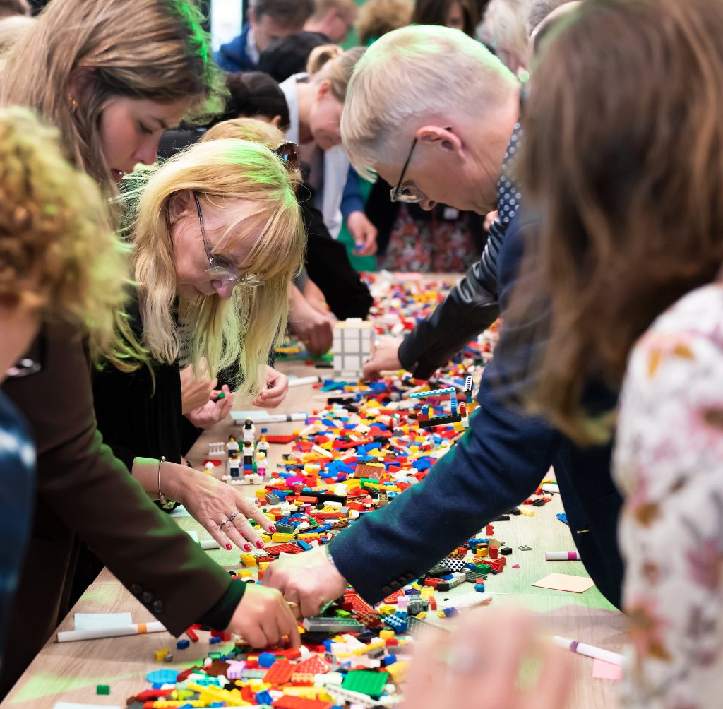 People building with LEGOs.